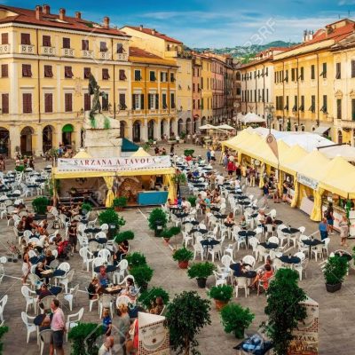 SARZANA, ITALY - AUGUST 10, 2015: Central historic square - Piazza Giacomo Matteotti in Sarzana town, Italy. People celebrate the local food fair.